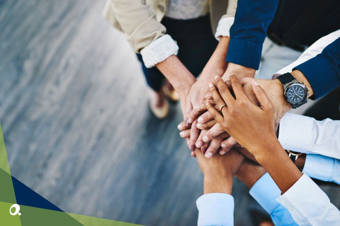 A team of financial professionals doing the "all in" hand gesture