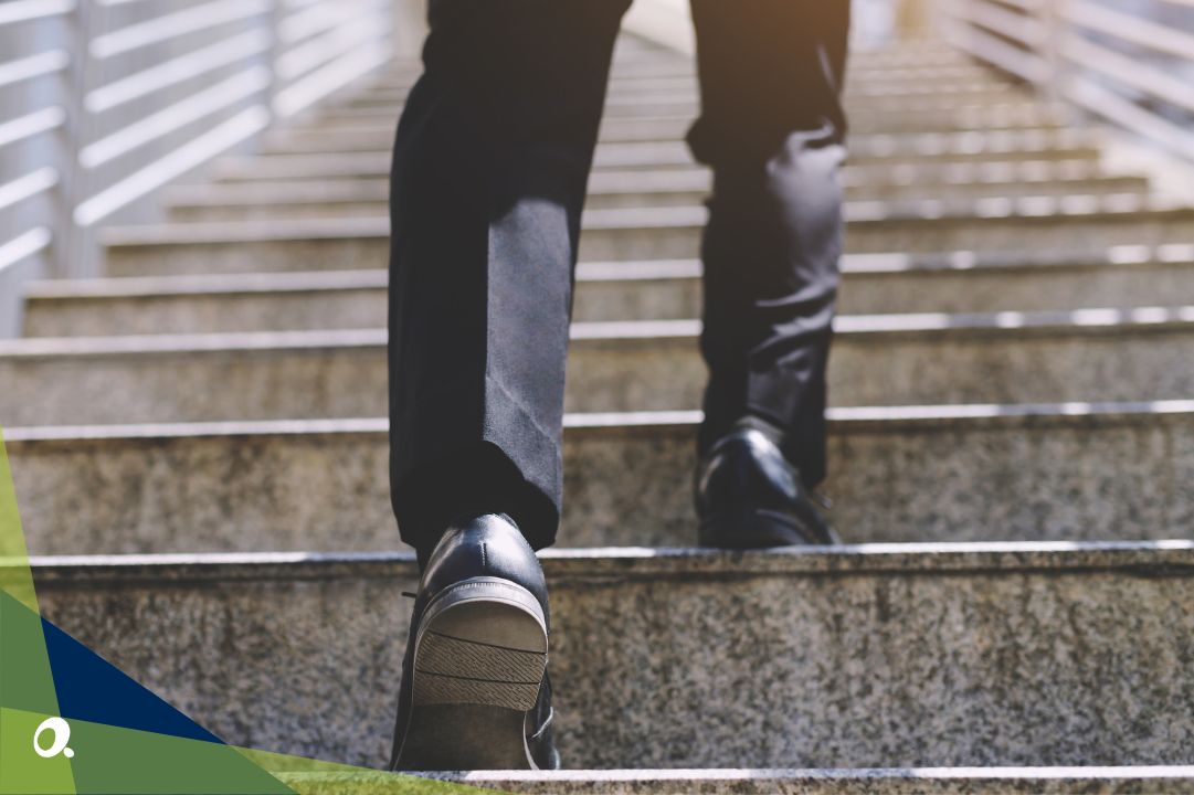 Professional walking up steps, symbolising progress towards a faster, more efficient month-end close process.
