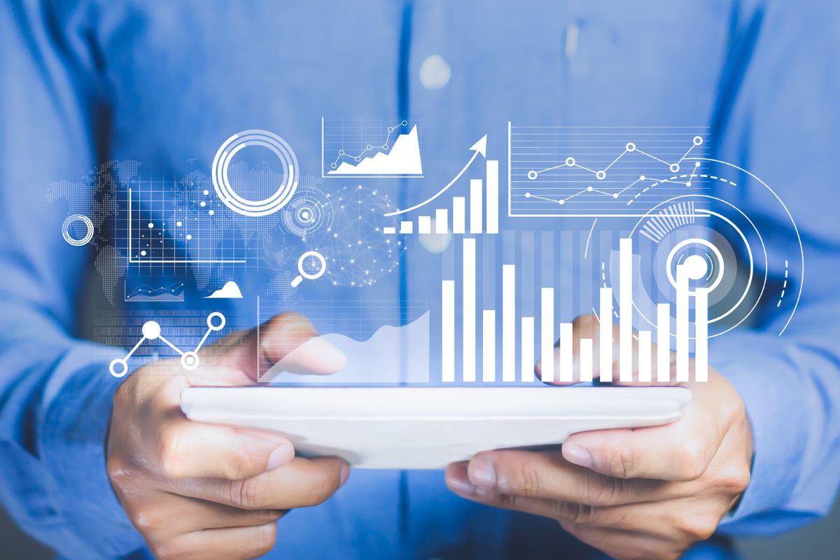 Man holding tablet with a digital graphic of data floating above the tablet